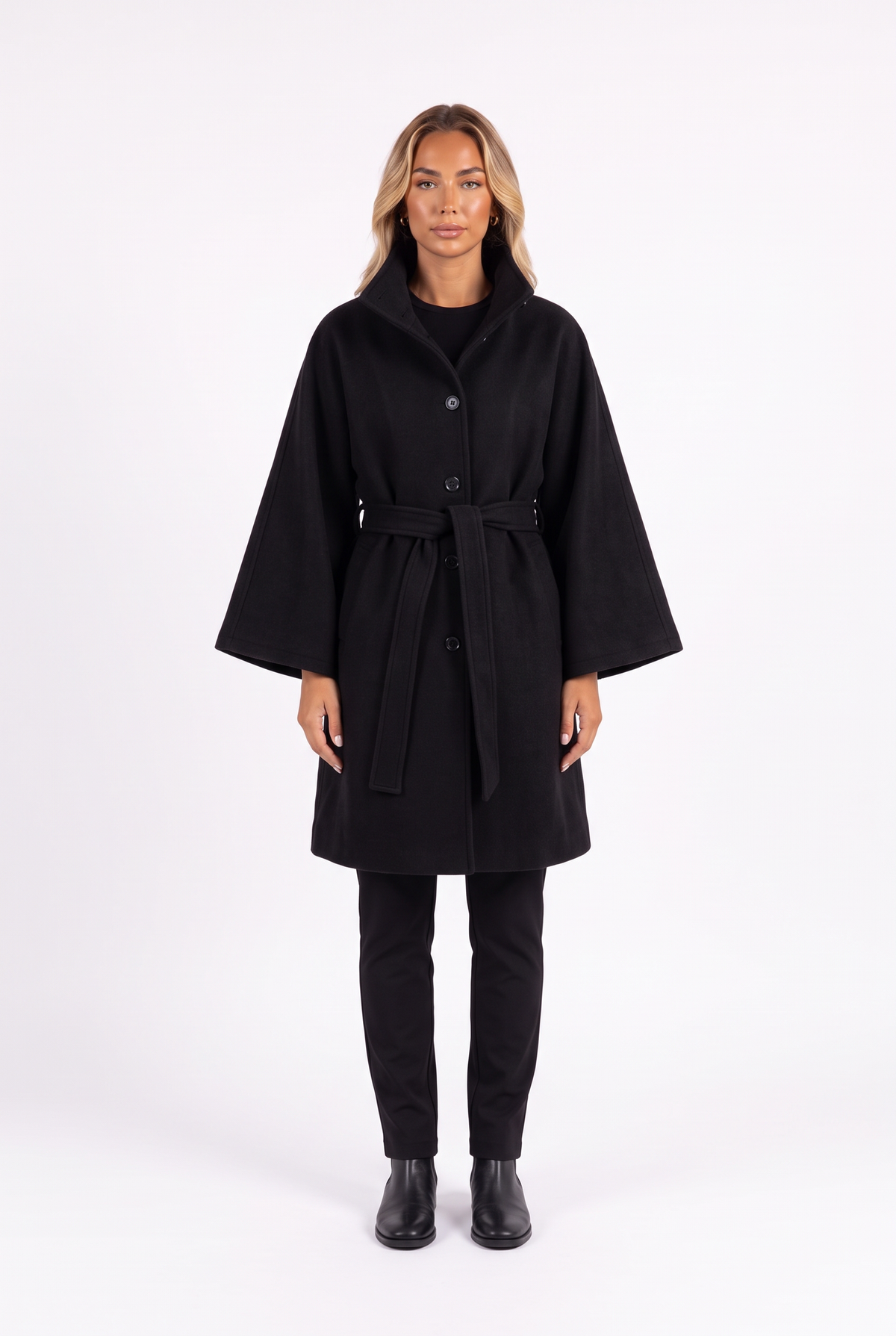 Belted cape jacket with funnel collar in black — front